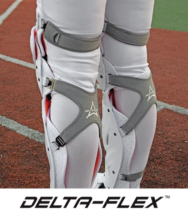 A close-up of a person's legs wearing All Star PHX Paige Halstead Fastpitch Catcher's Leg Guards (LGW-PHX), featuring the LINQ hinge system.