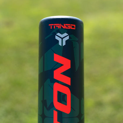 Close-up of the top of an Easton 2025 Tango (-8) 2 5/8" USA Baseball Bat (EUS5TNG8), a dark youth bat with "TANGO" in red and a gray geometric logo above "ICON," set against blurred grass. Brand: Easton.