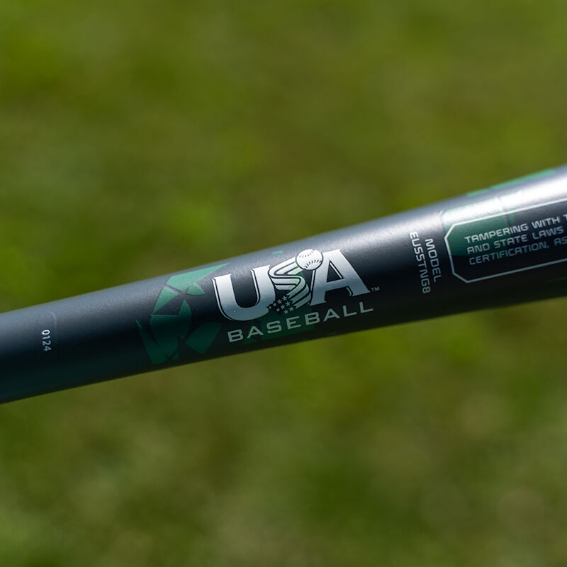 A close-up of the 2025 Easton Tango (-8) 2 5/8" USA Baseball Bat (EUS5TNG8) by Easton, featuring -8 certification and the USA Baseball logo, set against a blurred grassy background.