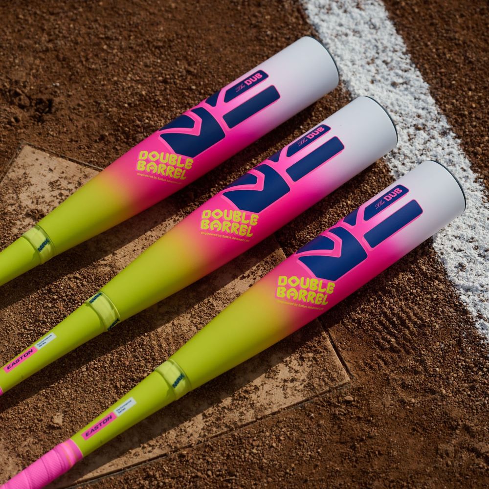Three vibrant Easton Dub (-10) 2 3/4" USSSA Baseball Bats with two-piece composite construction and Double Barrel technology are displayed side by side on a dirt field next to a white line.