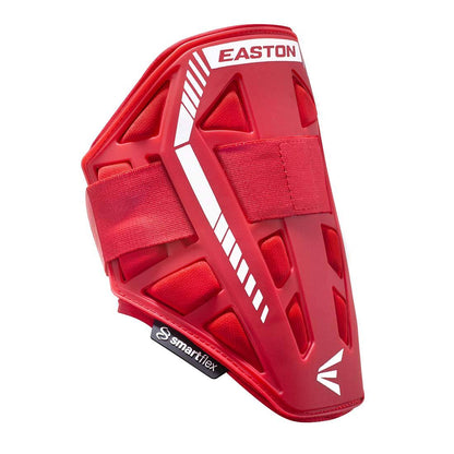 The red Easton Compact Batter Elbow Guard: ES37 features white accents, adjustable straps, and a vented geometric design for protection. Pair it with an Easton leg guard for full coverage. The smartflex logo appears on a black tag at the bottom.