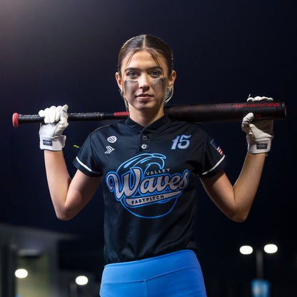 A woman holding the 2024 Easton Ghost Advanced (-9) Fastpitch Softball Bat (EFP4GHAD9), ready for the next pitch.