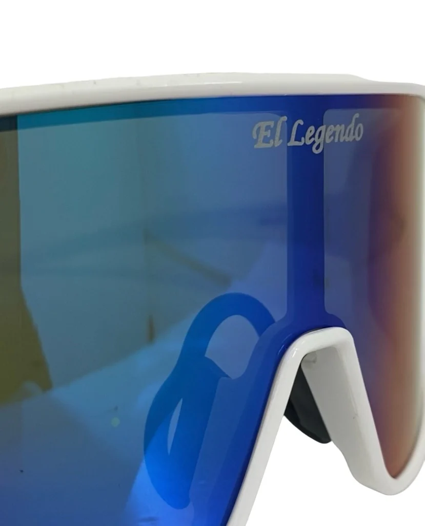 Close-up of reflective blue Akadema El Legendo Sunglasses (ELLEGENDO) with a white frame. "El Legendo" appears on the top right of the lens, blending Akadema style with UV400 protection.