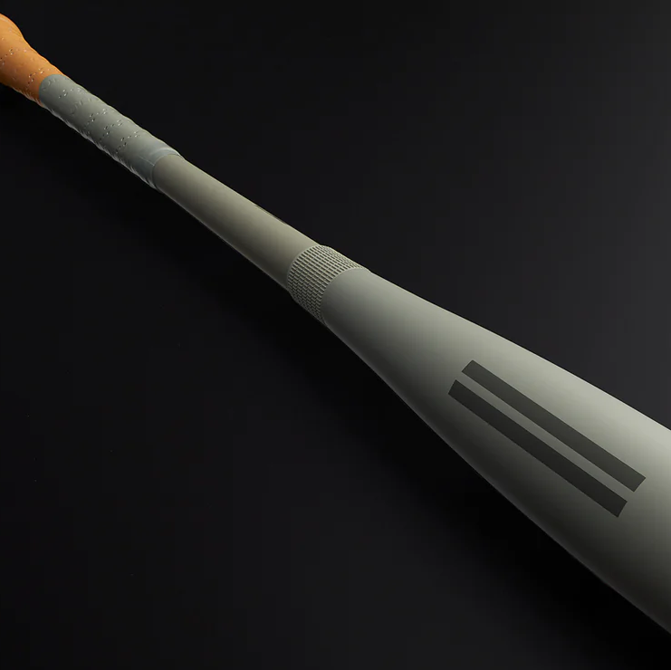 A close-up of a baseball bat with a wooden handle and a matte gray barrel, featuring two parallel black stripes on the barrel, set against a dark background.