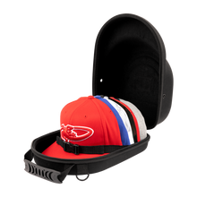 The Lizard Skins Hat Guardian: HATGD100 is a black, crush-proof hat case with a handle and interior strap, shown open to display several colorful baseball caps inside. The protective case is set against a plain background.