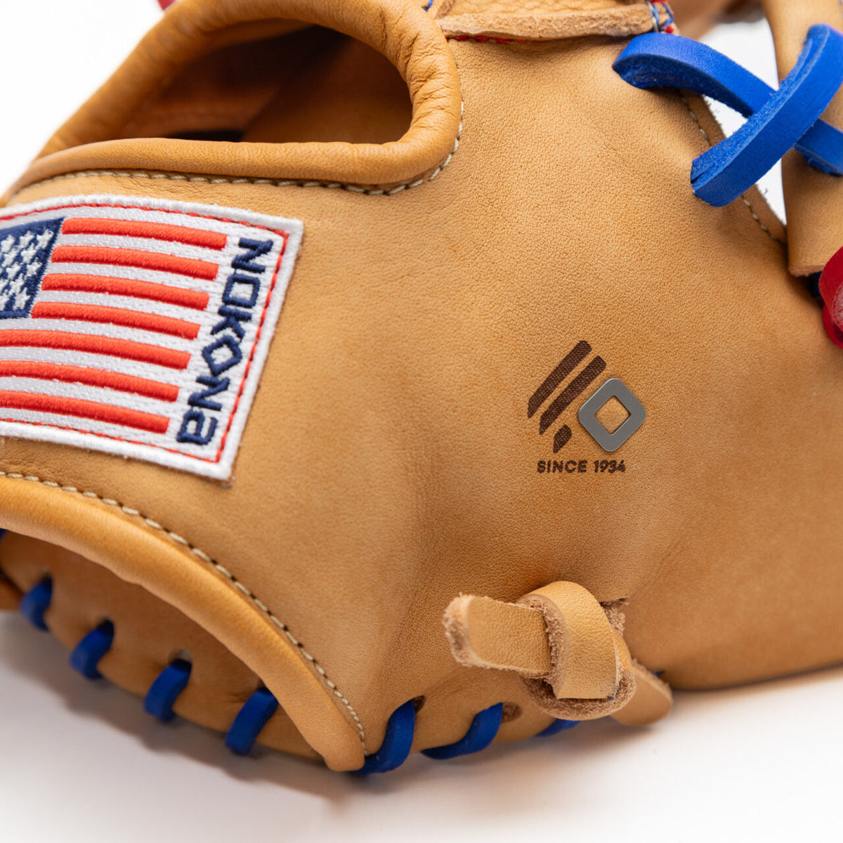 Nokona S1 All-American 11.5″ Baseball Glove S1-EP400POP in tan supersoft steerhide leather with blue laces, featuring an American flag patch and a Nokona logo with the text SINCE 1934 on the outer shell.