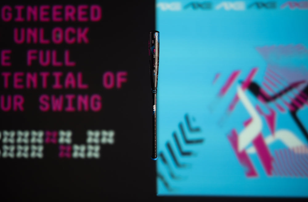 The 2024 AXE Avenge Pro 3 Hybrid (-8) 2 5/8" USA Baseball Bat: L174M features a black and blue design with pink text, from the AXE brand.