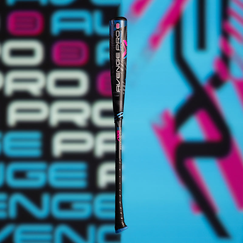 A black baseball bat with AVENGE PRO written on it in white, blue, and pink, is displayed upright against a blurred blue and pink background with repeating AVENGE PRO text.