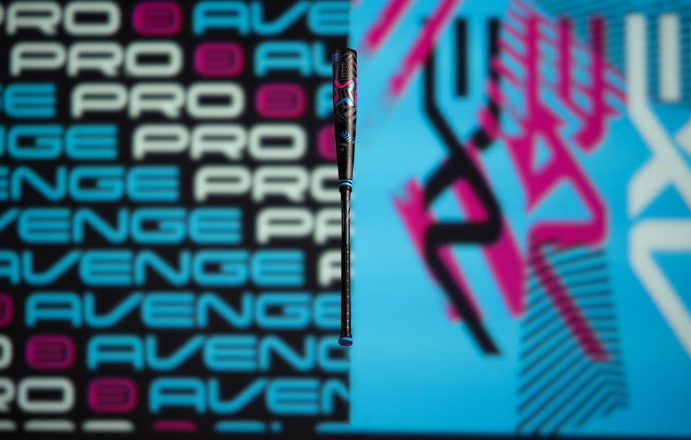 The 2024 AXE Avenge Pro 3 Hybrid (-8) USA Baseball Bat stands before a blue and pink backdrop, highlighting the cutting-edge design of the AXE L174M.