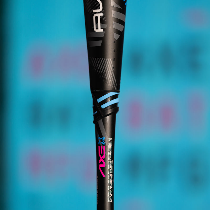 Close-up of a black baseball or softball bat with blue and pink accents and the word AXE visible on the handle, set against a blurred blue background.