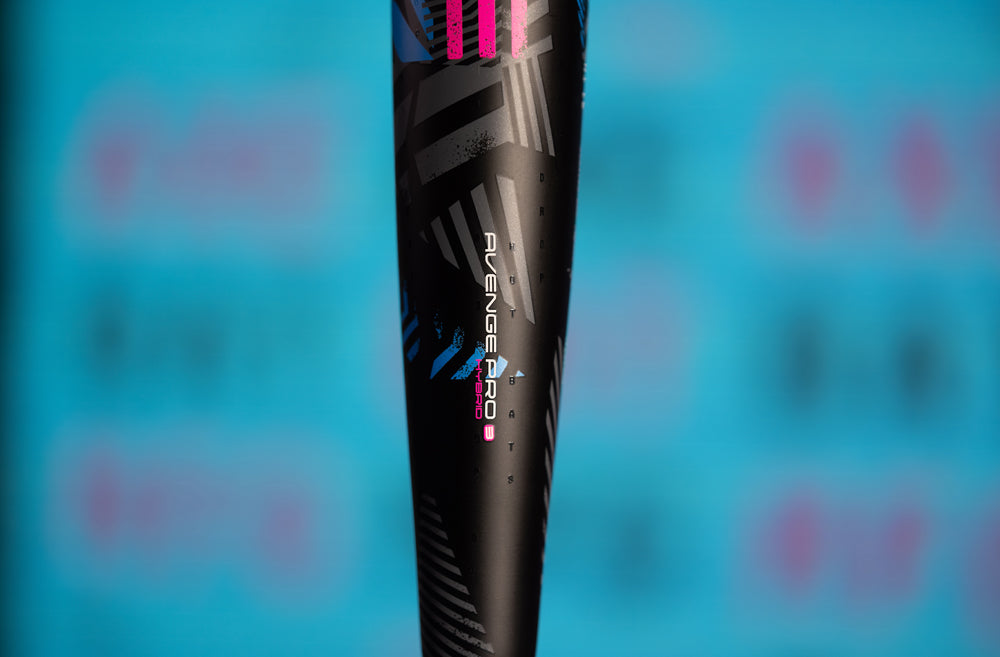 The 2024 AXE Avenge Pro 3 Hybrid (-8) USA Baseball Bat (L174M) features a bold black, pink, and blue design.
