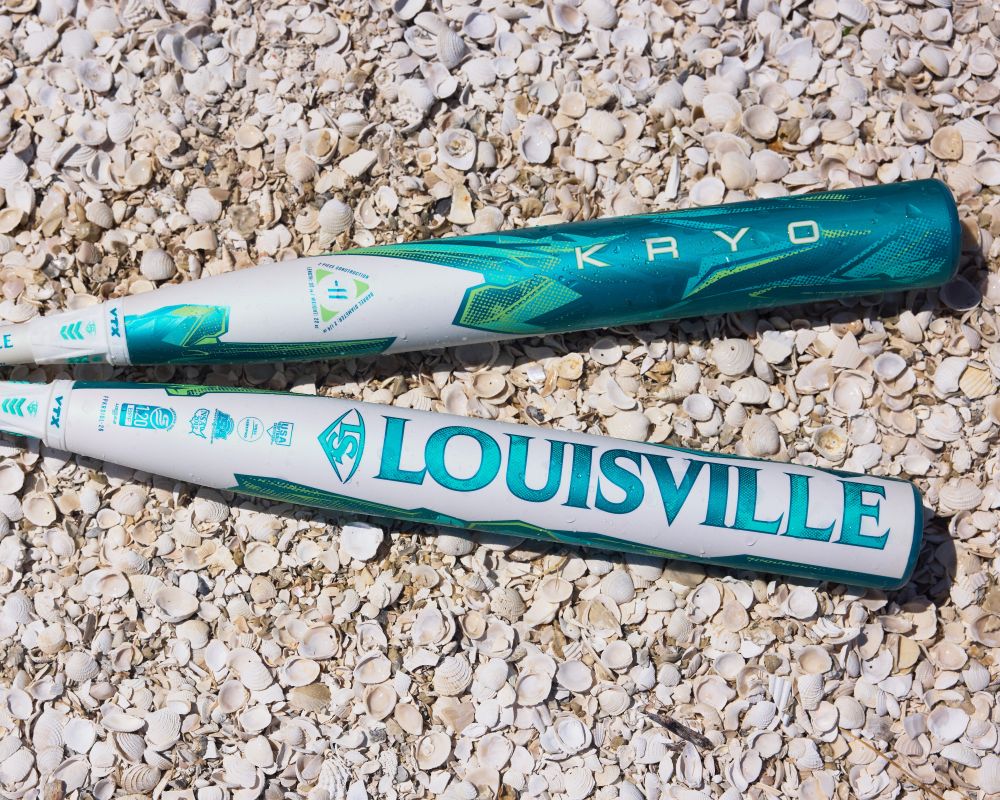 The 2026 Louisville Slugger Kryo (-9) Fastpitch Softball Bat (WBL4136010) sits atop a pile of shells, highlighting Louisville Slugger’s innovative gapped wall design.
