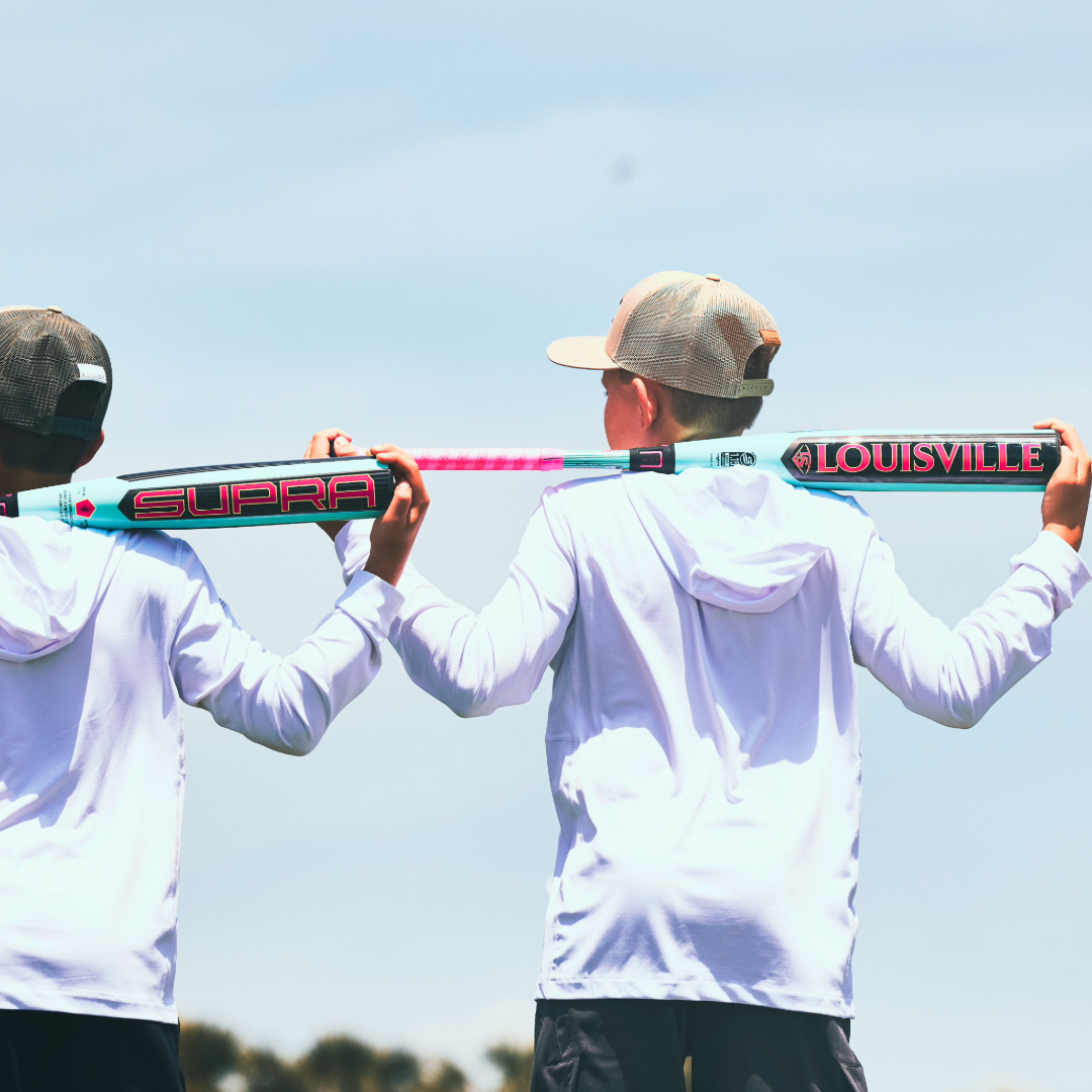 Two boys holding a Louisville Slugger 2026 Supra (-10) USSSA Baseball Bat (WBL4118010), ready for travel ball practice.