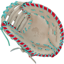 The Marucci Acadia 37S1 12.5" First Base Mitt (MFG3AC37S1-CM/R) features beige leather with red and teal laces, CAPTIA SERIES, HONOR THE GAME, and marucci embossed on the palm—expertly crafted by Marucci.
