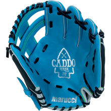 The Marucci Caddo 11" youth baseball glove (MFG3CD110-SB/BK) features blue full-grain cowhide leather, black and white lacing, an arrowhead design, "CADDO SERIES" on the palm, and the Marucci logo at the base.
