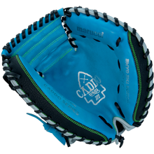 The Marucci Caddo 31" Baseball Catcher's Mitt (MFG3CD310-SB/BK) features a blue and black design with green stitching, “Caddo Series” and “Honor The Game” inside, and is crafted from full-grain cowhide leather for durability.