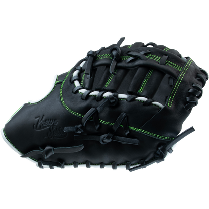 The Marucci Krewe 37S1 12.5" First Base Mitt features black premium cowhide leather with green stitching, black laces, and embossed branding, displayed against a white background.
