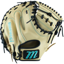 The Marucci Oxbow 235C1 33.5" Catcher's Mitt features tan full-grain cowhide leather, black laces, teal stitching, and a teal M logo on the wrist strap. The open mitt displays its inner palm and finger slots.
