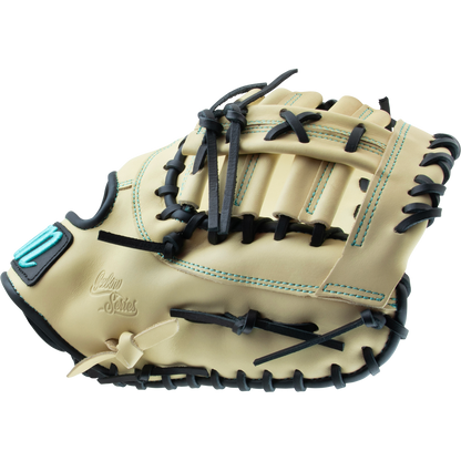 The Marucci Oxbow 38S1 12.75" First Base Mitt features tan full-grain cowhide leather, black pro-grade rawhide laces, teal stitching, an embroidered patch, and "Custom Series" text; shown side view on a white background.
