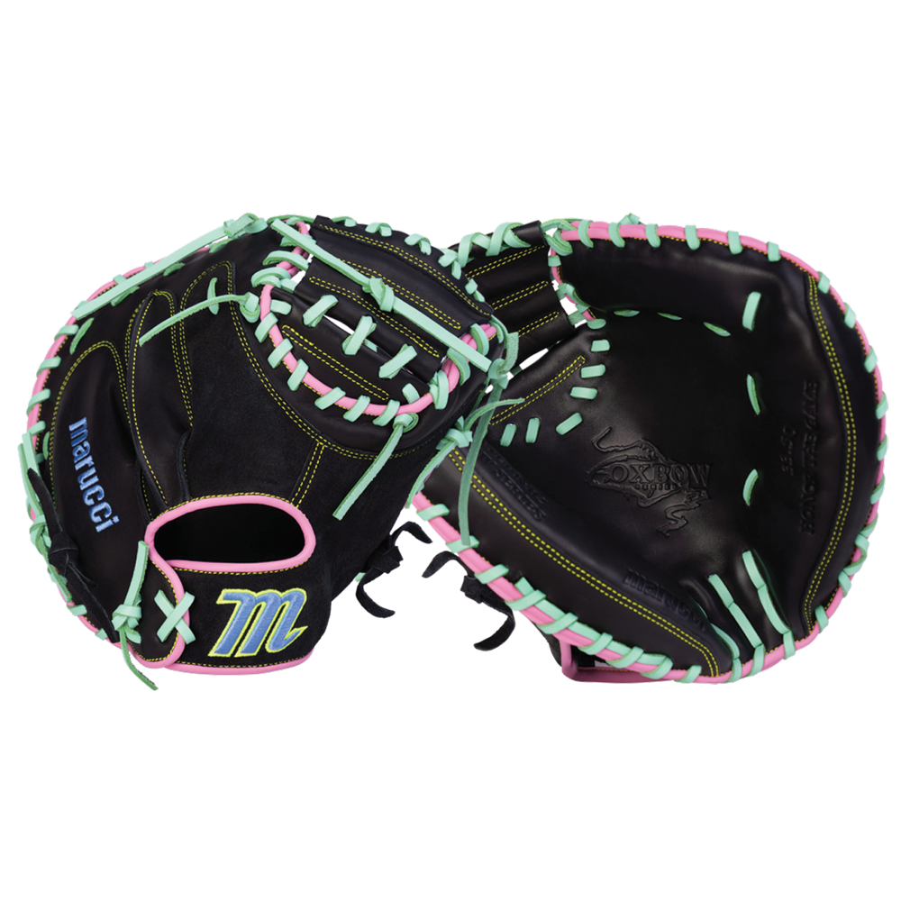 Two black Marucci baseball gloves crafted from full-grain cowhide leather feature mint green and pink laces, yellow stitching, and the word “Marucci” along with a blue and yellow M logo on one glove. One of the gloves is the Marucci Oxbow 235C1 33.5″ Baseball Catcher’s Mitt (MFG4OX235C1-BK/RO), an ideal choice for catchers.