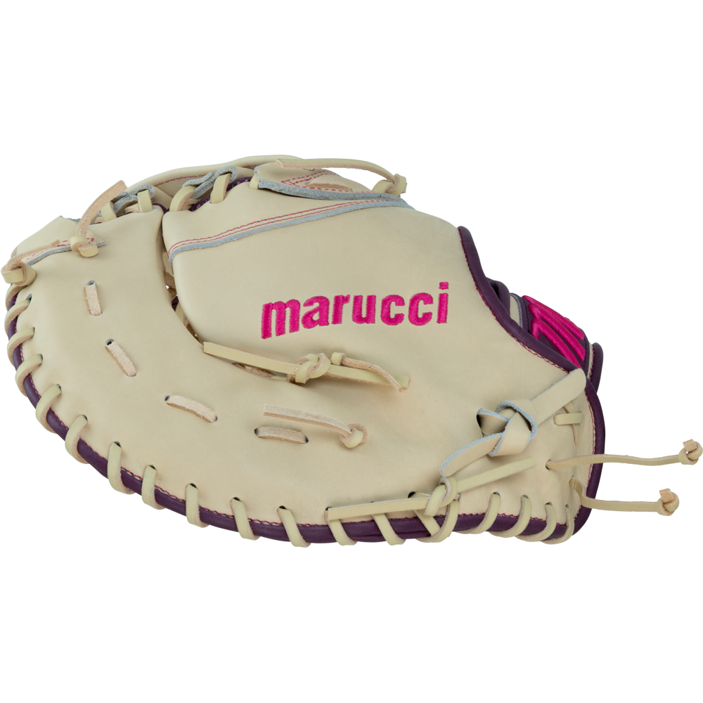 A Marucci Ascension 39S2 13″ Fastpitch First Base Mitt (MFGASFP39S2-CM/PR) is shown from the side, featuring a beige premium steerhide shell leather with purple trim and pink lettering. The glove displays visible laces, an H-Web design, and intricate stitching, highlighting its detailed craftsmanship by Marucci.