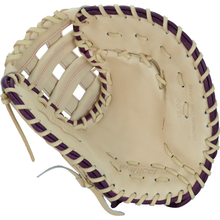 The Marucci Ascension 39S2 13″ Fastpitch First Base Mitt (MFGASFP39S2-CM/PR) by Marucci features a tan and dark brown design with visible stitching and lacing, crafted from durable steerhide shell leather, and has “HONOR THE GAME” embossed on the inner palm area.