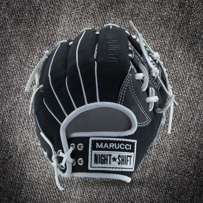 The Marucci NightShift CHUCK T 11.5" Baseball Glove (MFGNTSHFT-0103), black with white laces and gray accents, is shown on a textured gray background, displaying MARUCCI, NIGHT SHIFT, and Glove Cowboy patches.