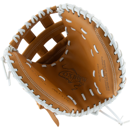 A tan Marucci Oxbow 240C2FP 33" fastpitch catcher's mitt, made of full-grain cowhide leather with white laces, is open and viewed from above, displaying the Marucci logo and text stamped inside the glove.