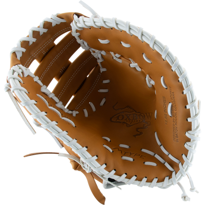 The Marucci Oxbow 37S1FP 12.5" Fastpitch First Base Mitt features tan leather, white laces, a two-bar post design, detailed stitching, and the Marucci logo stamped inside the palm—ideal for fastpitch play.