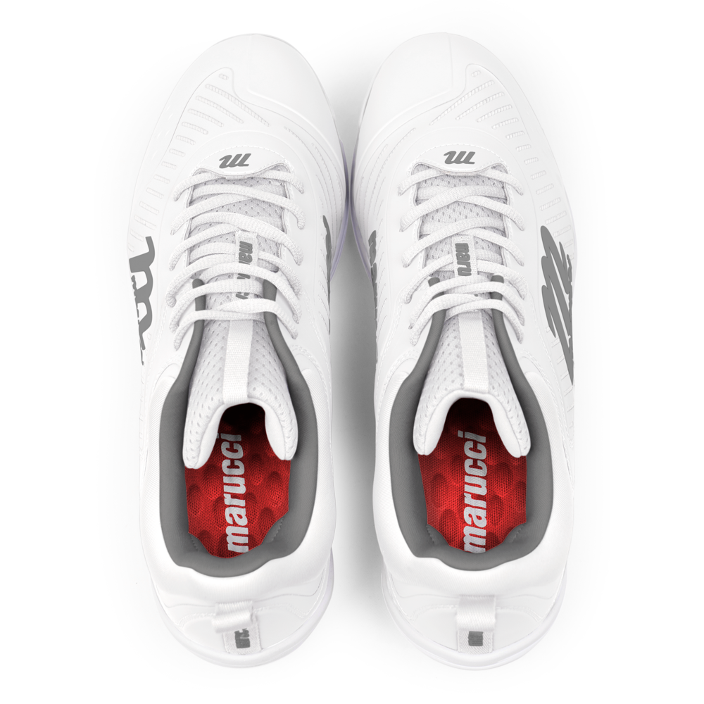 A pair of Marucci CFT Low Molded Cleats: MFWCTML in white, shown from above with black "M" logos on the tongues and red insoles featuring white Marucci branding—ideal for peak athletic performance.