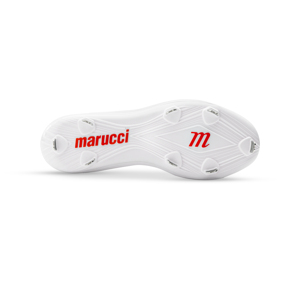 The image shows the bottom of a white Marucci CFT Low Metal Cleats: MFWCTSL with six metal spikes. The sole features the "marucci" name and a red "m" logo, both in red.