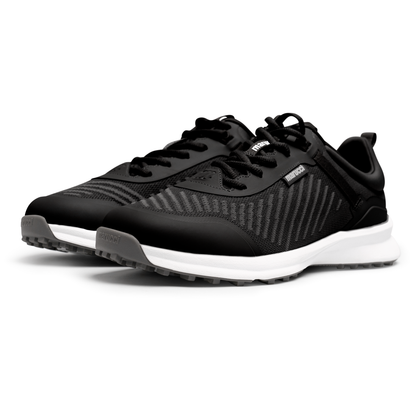 The Marucci CFT Turf Shoes (MFWCTT) by Marucci feature black mesh uppers, white soles, black laces, advanced cushioning, and a traction rubber outsole, shown side by side on a white background.