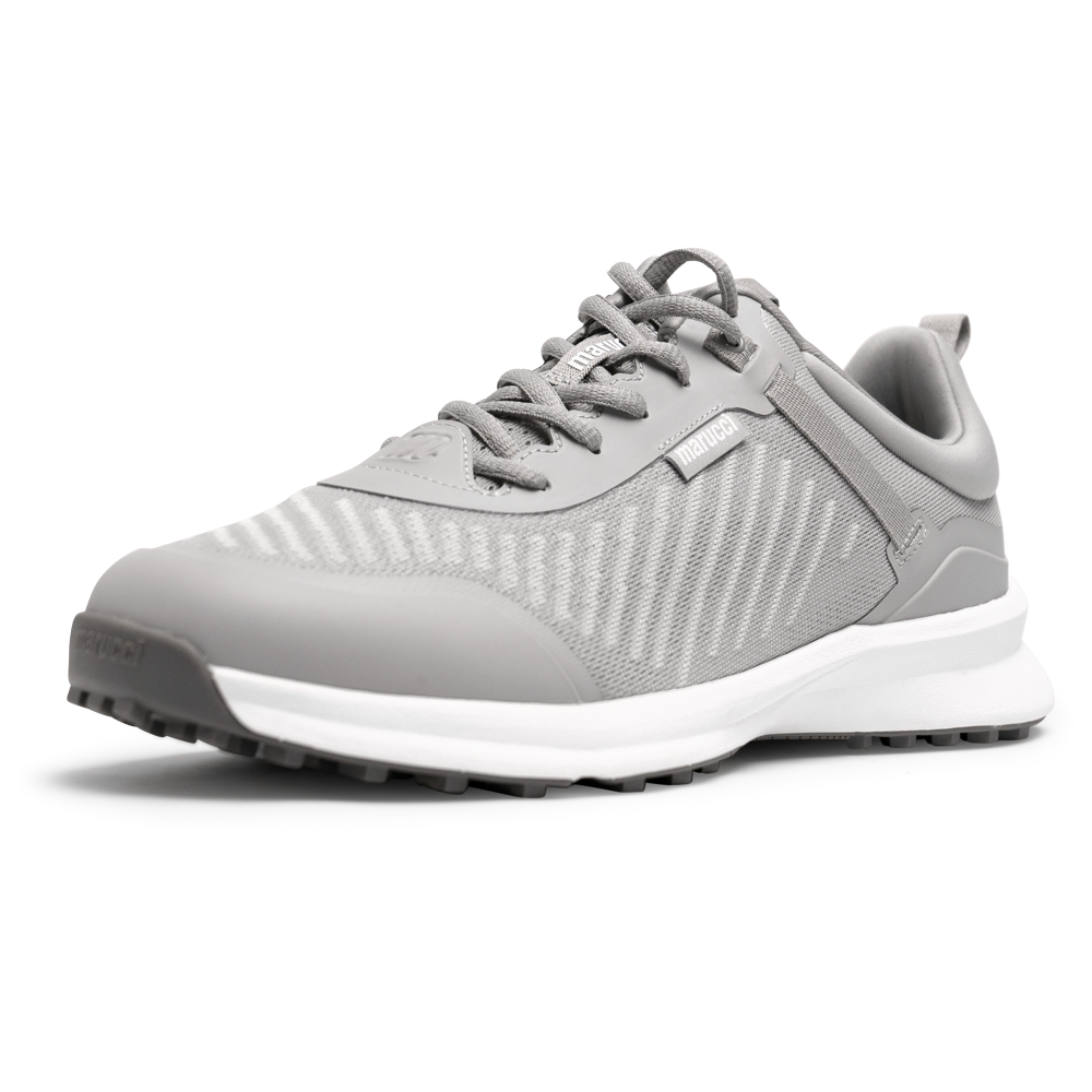 The Marucci CFT Turf Shoes: MFWCTT, in gray with a mesh upper, white sole, and laces, are displayed front-side on a white background. They feature advanced cushioning and a traction rubber outsole for comfort and grip.