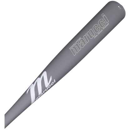 A close-up of the Marucci One-Hand Trainer Wood Bat: MONEHANDTB-GG—a gray training bat with the Marucci brand name and logo printed in white on the barrel—designed to enhance top-hand strength and hand-eye coordination during practice.