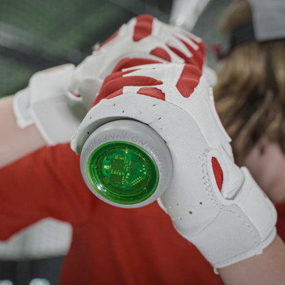 Close-up of a baseball player gripping the Marucci 2024 CATX SMART (-5) 2 3/4" USSSA Baseball Bat (MSBCXS5), equipped with a Diamond Kinetics sensor on the knob; player’s face is partially visible and out of focus in the background.