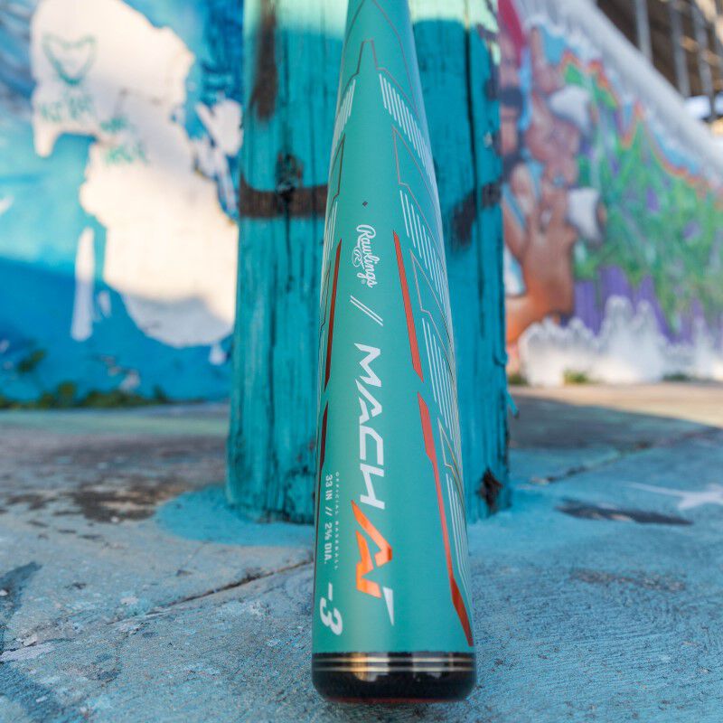 A 2024 Rawlings Mach AI (-3) BBCOR Baseball Bat: RBB4MC3 (USED) rests on a concrete surface.