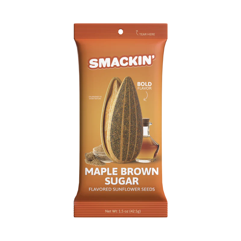 A 1.5oz bag of Smackin' Sunflower Seeds - Maple Brown Sugar flavor features bold orange packaging with a sunflower seed, brown sugar cubes, and syrup jar illustration. Text: “Bold Flavor” and “Net Wt. 1.5 oz (42.5g).”.
