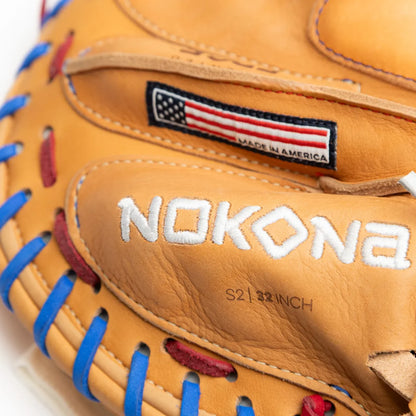 Tan leather Nokona S1 All-American 32″ Baseball Catcher’s Mitt: S1-EP2POP featuring an American flag patch, embroidered branding, and red and blue lacing.