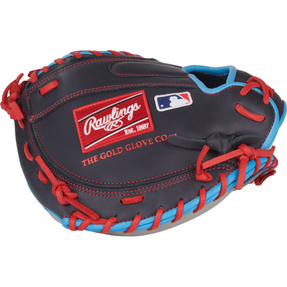 The Rawlings NXT 32.5″ Baseball Catcher’s Mitt (NXTCM325UNG) is a black and red youth catcher’s mitt with blue accents, featuring the iconic Rawlings logo patch and MLB logo on the back. Crafted from pro-soft leather for enhanced comfort and durability, it’s an excellent choice for young catchers.