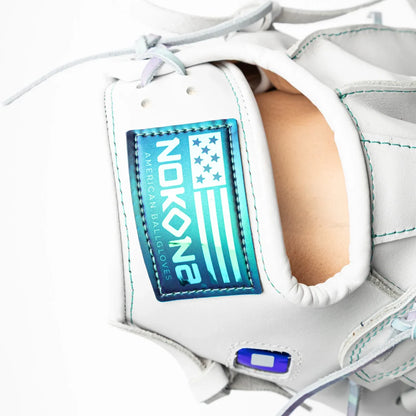 Close-up of a white Nokona Halo 12″ Fastpitch Glove: WHT-EP1200H with a blue and teal iridescent brand logo patch on the wrist strap.