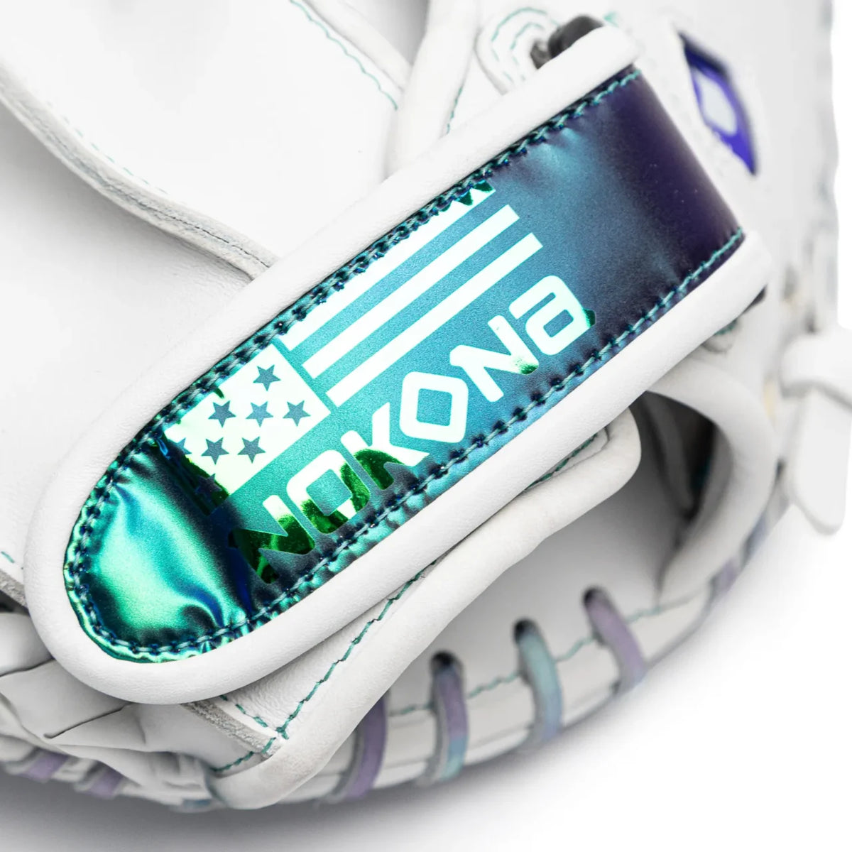 Close-up of a white Nokona Halo 32.5″ Fastpitch Catcher’s Mitt: WHT-EPV3250C featuring a wrist strap with a holographic finish displaying a flag icon and text.