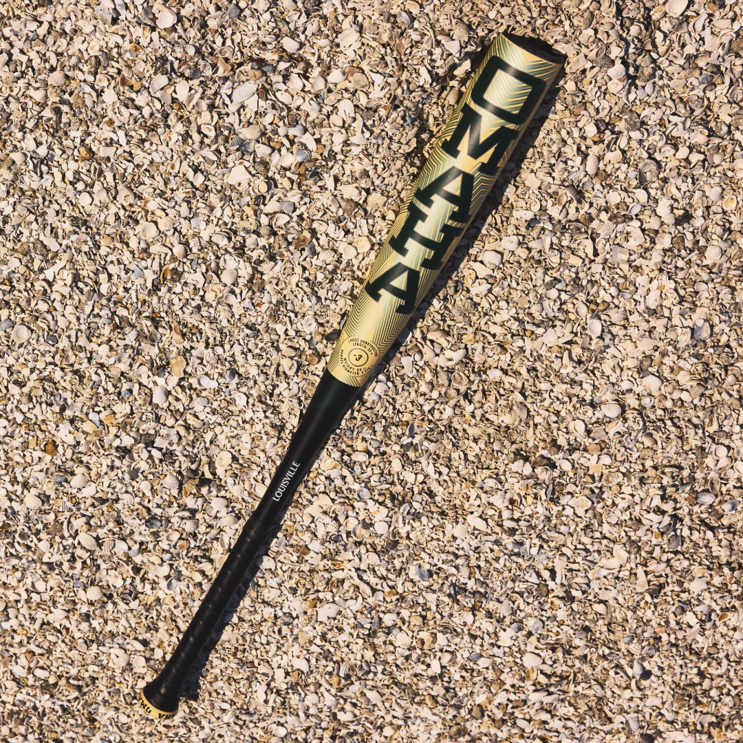 A 2026 Louisville Slugger Omaha (-3) BBCOR Baseball Bat (WBL4117010) by Louisville Slugger lies on the ground.