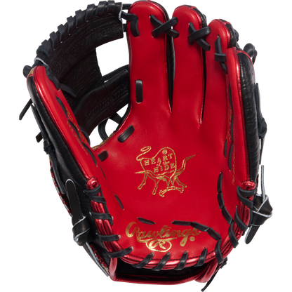 The Rawlings Heart of the Hide 11.5" Baseball Glove (PROGOLDYX, RGGC June 2026) features a red and black design, gold-embossed bull logo on the palm, Gold Glove Club detail, and Rawlings branding in gold near the wrist.