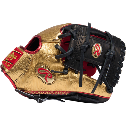 The Rawlings Heart of the Hide 11.5" Baseball Glove - RGGC June 2026: PROGOLDYX stands out with its gold and black design, red accents, intricate patterns, and prominent Rawlings logos on the side and wrist strap.
