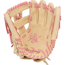 The Rawlings Heart of the Hide 12" Fastpitch Glove (PRO120SB-32CP) features a tan design with pink laces and stitching, plus signature branding on the palm and wrist, offering dedicated players both style and performance.