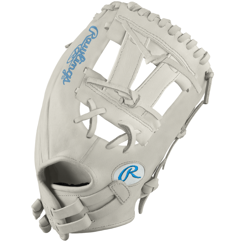 The Rawlings Heart of the Hide 12" Frost DSG Exclusive Fastpitch Glove (PRO120SB-7WCBDSG) in light gray features blue logos, an open web, and leather laces—ideal for softball players seeking top performance and stylish design.