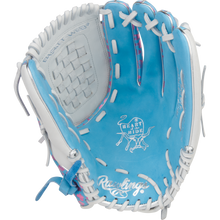 The Rawlings Heart of the Hide 12.5" Fastpitch Glove (PRO125SB-3CBW) features a blue and white design with white laces, pink accents, a basket web, and the iconic Heart of the Hide logo.
