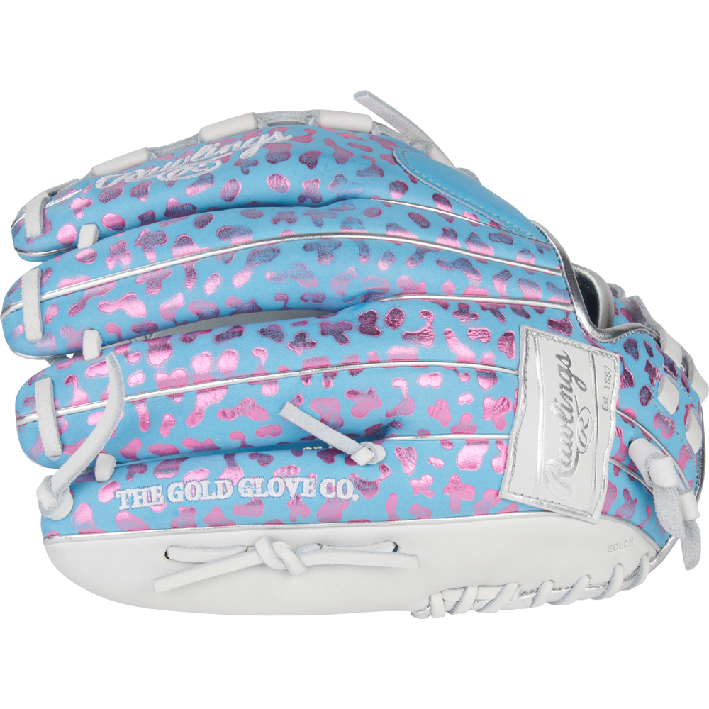 The Rawlings Heart of the Hide 12.5" Fastpitch Glove (PRO125SB-3CBW) features a light blue design with pink leopard spots, white lacing, and "THE GOLD GLOVE CO." stamped in white for a bold and colorful look.
