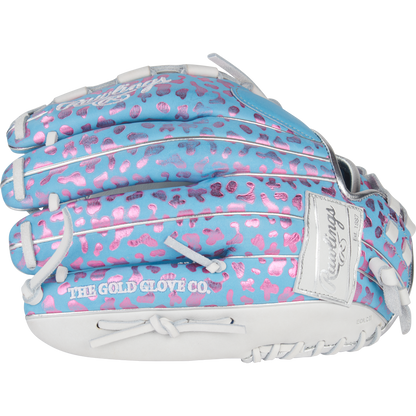 The Rawlings Heart of the Hide 12.5" Fastpitch Glove (PRO125SB-3CBW) features a light blue design with pink leopard spots, white lacing, and "THE GOLD GLOVE CO." stamped in white for a bold and colorful look.