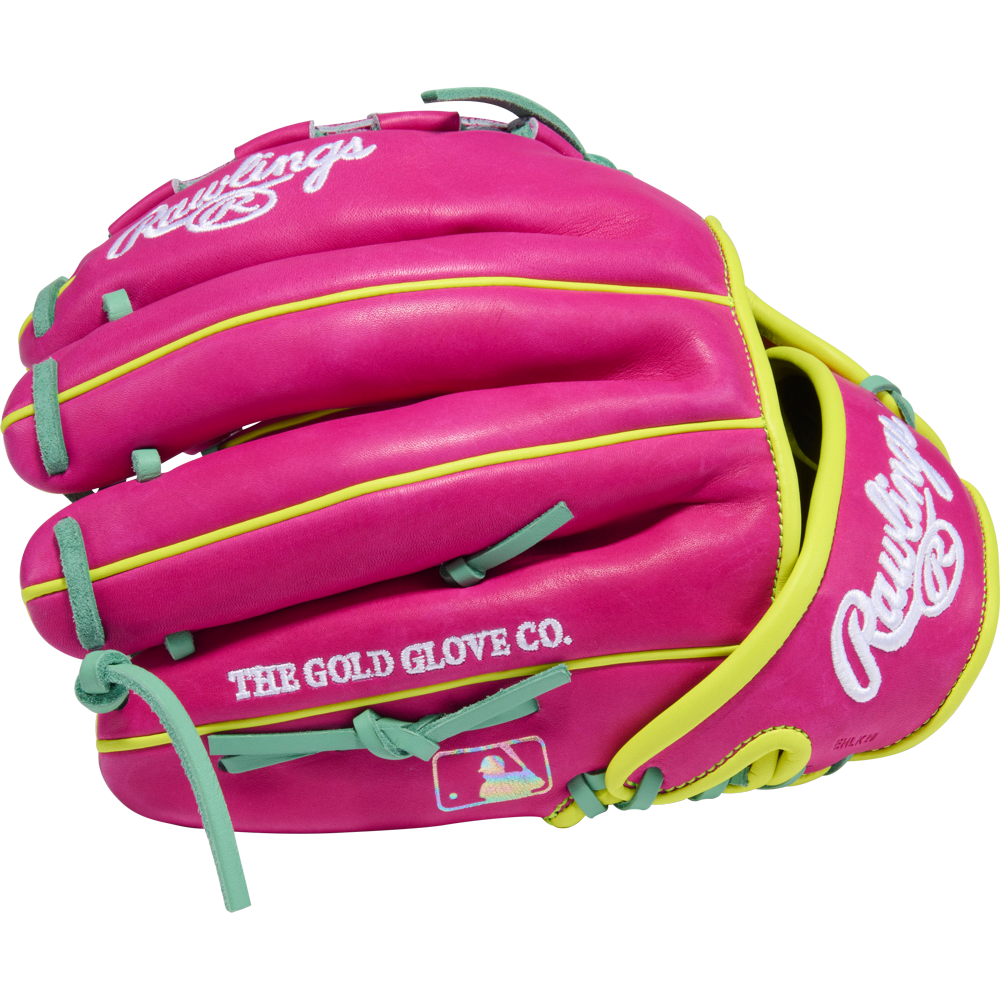 The Rawlings Heart of the Hide 12" Baseball Glove (PRO206TRI-34BE) features bright pink leather with yellow trim, teal laces, white branding, THE GOLD GLOVE CO. text, and the MLB logo—perfect for pitchers.